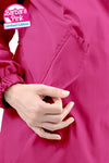 Close-up of a person's hand holding their Pakistan pink colored looselyboho BARBARA PINK WINDBREAKER, crafted from lightweight water-resistant fabric, which features a stitched pocket on the front and an elasticated sleeve. Text at the top left corner reads "Barbara Pink Windbreaker, Limited Edition".